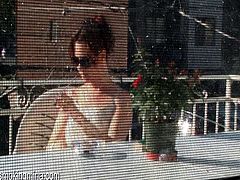 Cute chick smokes on the porch as he films it