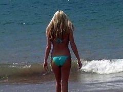 What are you waiting for? Watch this blonde angel, with huge gazongas wearing a cute bikini, while she plays with your mind next to the ocean.