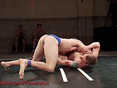 Watch two hot and muscular gay hunks making their bodies sweat while enduring a hot wrestling match.