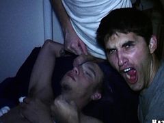 A brunette dude gets banged by two blond guys in gay sex video