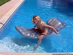 Watch this smoking hot blonde babe pour water from a hose on her body while she's in the pool in this amazing solo scene.