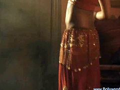 This Indian chick is quite a beauty. She dances in traditional clothes and she reveals her breasts and bare back. She moves her hips in a very sensual manner.