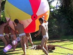 Many gays are having a party in the garden. They show their nude bodies to each other and then one of them kneels in front of his BF and gives him a blowjob.