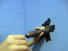 An Asian girl has fun in a gloryhole video. This nude babe drops to her knees and gives a handjob with a smile on her face. Of course she also sucks that large dick.