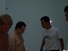 A group of dudes watch at wild gay sex in the shower. Some slim guy lies down on the floor and gets ass fucked doggystyle.