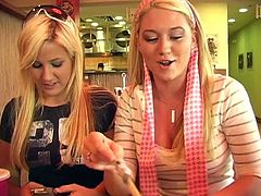 Alison Angel and her female friend talk on camera in some cafe. Alison also pulls down a t-shirt to show her juicy boobs.