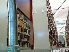 Playful girl teases her friend on webcam. While sitting in a public library she flashes her tits and plays with her pussy.