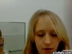 Cute blondie teases her friend on webcam while sitting in a public library. She then goes to the restroom where she takes off her clothes showing her tempting body.