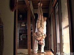 Submissive Japanese girl Sayoko strips and shows her nude body to a man. Then the dude binds the chick and hangs her up.