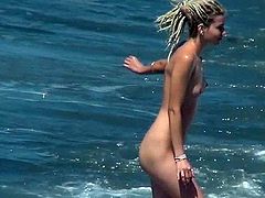 Voyeur must feel amazingly horny while whatching this beautiful gal posing her nude forms while at the beach