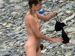 Lusty voyeur must have an amazing time spying on this nude beauty while at the beach
