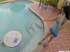 Entertain yourself by watching this babe, with small boobs wearing shorts, while she goes hardcore with a guy outdoors next to a pool.