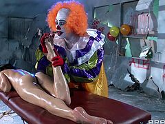 Gorgeous brunette gets a sexy oily massage from a clown and ends up getting her mouth filled with his hot cum after a hardcore fuck.