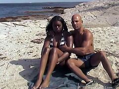 The beautiful ebony Sweetie gets her little pussy rammed on the beach and ends up taking a nasty cumshot on her lovely face.