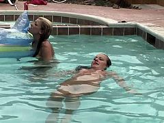 Two kinky nude blondes are having fun in a pool. The girls stroke each other's nude bodies, then rub their pussies against each other.