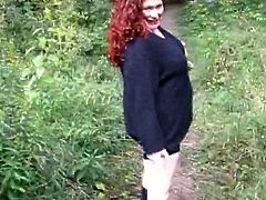 Chubby redhead hussy Jennifer Van Balvert is having fun with a guy outdoors. She masturbates her twat and kneads her huge hugs, then kneels in front of the man and sucks his wang.