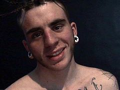 Cotton is a tattooed twink with a funky hairdo and a big stiff cock. He jerks off while watching some porn video and he dumps his load of sperm in his hand.