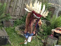 Pinky is out in her backyard dressed up as an Indian chief. She spreads her legs open wide and sticks her fingers into her pussy. She sticks the whole palm of her hand and all of her fingers into her wet vagina.