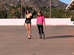 The gorgeous lesbian babes Elle and Malena get a little horny as they get naked and finger their hot pussies outside in a parking lot.