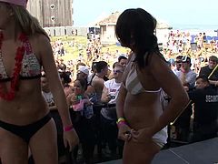 A few hot bitches, wearing bikinis, are having a good time at an outdoor party. They show their bodies on the stage and shake their butts crazily.