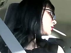 Looks like someone is driving sexy Mina somewhere. She turns on the camera and lights up a cigarette. She smokes and teases until she finishes the cigarette.