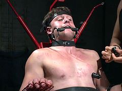 Will this gay slave be able to handle it. The master has hooked up electrodes to the slaves genitals and sends sharp, painful jolts through the slave's penis and balls. It look like he cant' handle the 30 minutes of torture as he bits down firmly on the bit in his mouth.