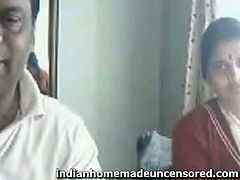 It looks like this Indian couple has their webcam on. At some point, she unbuttons her shirt and shows off her tits. Then, she dresses back on. They are exhibitionists.