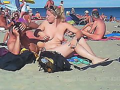couple fucks at the beach, soon there's a crowd watching and fucking.