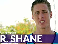 Mr. Shane is here to stretch your imagination and spread his charm far and wide. This lean and long So Cal beach bum can generally be found doing something active outdoors, whether it’s holding court with a basketball or just unwinding with a bit of martial arts. Spreading out on the sofa, he watches a scene as his towel falls open, exposing his hard cock, begging for some attention.