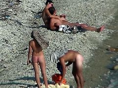 Couple fucking on a public beach, while walking past people