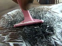 He surely wants it clean and smooth as this huge cock black hunk shaves sweet ebony hairy pussy before fucking her hard.