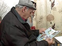 A guy reading a magazine her baby