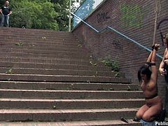 Brunette Hungarian milf with nice big tits is getting publicly humiliated by her mistress Harmony. The domina tied her on stairs, where people are watching Angelica's nice naked body, as she is getting teased by vibrator. Later she is blindfolded and a guy pushed his hard cock in her mouth.