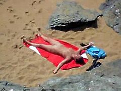 Nude girl on beach sunning.