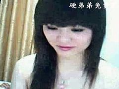 Sweet Japanese girlie plays with fake cock on webcam