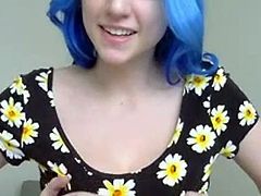 Blue haired girl in flowers plays with tits