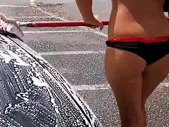 Girl in swimsuit at the car wash