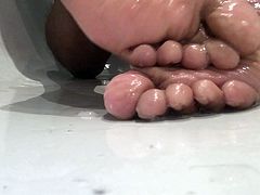 Oily teen boy feet in the bath