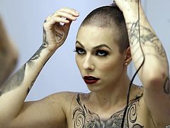 This is one crazy lady. She shaved her head and came out to the living room in such a skimpy outfit. It is clear that she wants to be fucked hard by both of these dudes. She had a cock in her mouth and one is in her wet cunt.