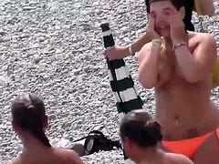 slim teen with big boobs on public beach orange swimsuit