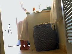 voyeur cam catches unaware MILF dressing