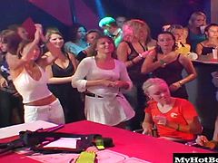 They cant get enough cock and they have no problem taking turns sucking on them while an audience watches and encourages them along. The cocks are hard the ladies horny and the club is just getting going. Check it out as these ladies throat strangers cock in front of a room full of voyeurs.