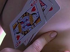 Playing cards cover her tits and cunt in a sensual tease