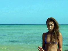 Teen beauty showing off her tiny bikini on the beach