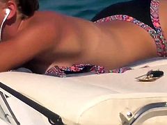 blonde teen flashing her small white boobs tanning on boat