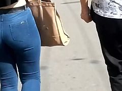 Hot girl in tight jeans walking on the street