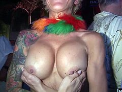 They pull off their shirts to let you have a look at heir large natural boobs. Next, a couple MILFs will flash their hooters at you, along with one blonde who gives you a close up of her perky knockers and big, suckable nipples plus, one older BBW lady will pull off her bra and show off her floppy tits.