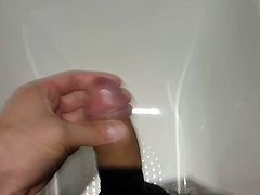 Stroking cock in hotel bath and pissing foreskin pulled back