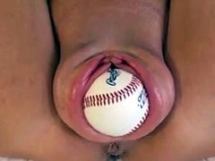 She fits a whole baseball inside her cunt
