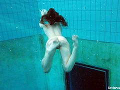 Seductive red haired swimmer Katrin Bulbul gets naked under the water